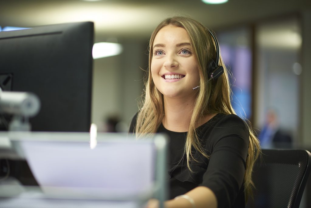 Lady with headset on working at a computer