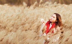 Lady in cornfield posing for photographs